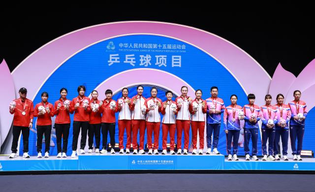 (251119) -- MACAO, Nov. 19, 2025 (Xinhua) -- Gold medalists team Shandong, silver medalists team Hebei and bronze medalists team Shanghai pose during the awarding ceremony for women's team of table tennis at China's 15th National Games in Macao, south China, Nov. 19, 2025. (Xinhua/Liang Xu)