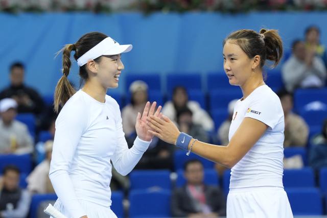 (251119) -- HENGQIN, Nov. 19, 2025 (Xinhua) -- Wang Xinyu/Yuan Yue (R) react during the tennis women's doubles final between Wang Xinyu/Yuan Yue of Guangdong and Wang Yafan/Jiang Xinyu of Sichuan at China's 15th National Games in Hengqin, south China's Guangdong Province, Nov. 19, 2025. (Xinhua/Yan Linyun)