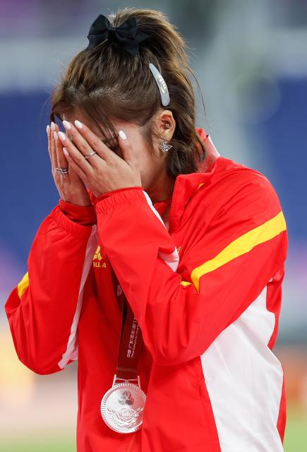 (251119) -- GUANGZHOU, Nov. 19, 2025 (Xinhua) -- Silver medalist Wu Yanni of Sichuan sheds tears during the awarding ceremony for the women's 100m hurdles of athletics at China's 15th National Games in Guangzhou, south China's Guangdong Province, Nov. 19, 2025. (Xinhua/Zhou Mu)