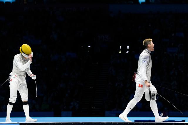 (251119) -- HONG KONG, Nov. 19, 2025 (Xinhua) -- Cheung Ka Long (R) of Hong Kong celebrates scoring on Chen Haiwei of Fujian during the men's team foil final of fencing at China's 15th National Games in Hong Kong, south China, Nov. 19, 2025. (Xinhua/Wu Lu)