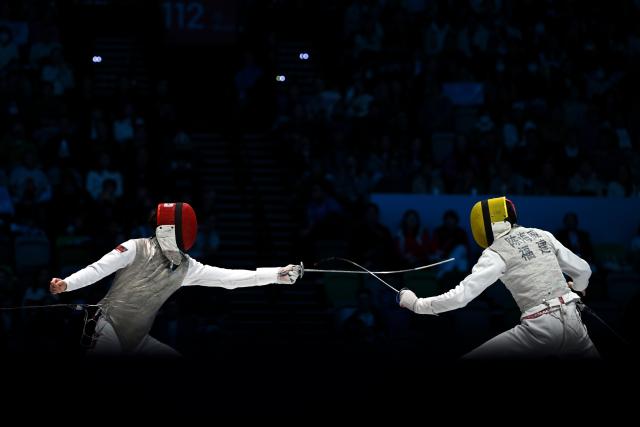 (251119) -- HONG KONG, Nov. 19, 2025 (Xinhua) -- Choi Chun Yin (L) of Hong Kong competes against Chen Haiwei of Fujian during the men's team foil final of fencing at China's 15th National Games in Hong Kong, south China, Nov. 19, 2025. (Xinhua/Hu Huhu)