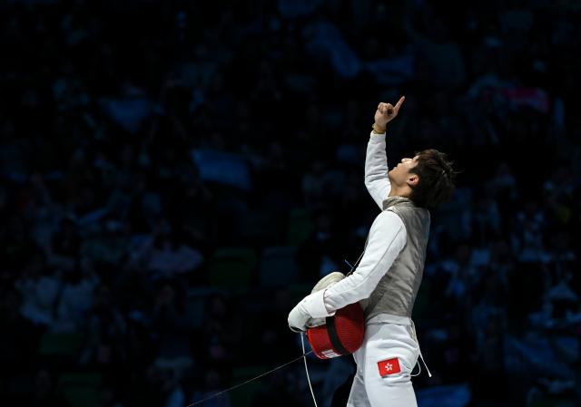 (251119) -- HONG KONG, Nov. 19, 2025 (Xinhua) -- Choi Chun Yin (L) of Hong Kong celebrates after winning the men's team foil final of fencing at China's 15th National Games in Hong Kong, south China, Nov. 19, 2025. (Xinhua/Hu Huhu)