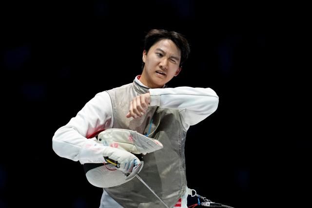 (251119) -- HONG KONG, Nov. 19, 2025 (Xinhua) -- Leung Chin Yu (R) of Hong Kong reacts during the men's team foil final of fencing at China's 15th National Games in Hong Kong, south China, Nov. 19, 2025. (Xinhua/Wu Lu)