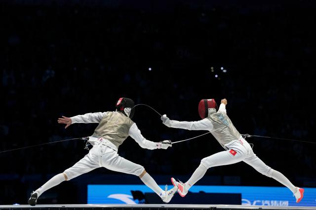 (251119) -- HONG KONG, Nov. 19, 2025 (Xinhua) -- Choi Chun Yin (R) of Hong Kong competes against Xu Jie of Fujian during the men's team foil final of fencing at China's 15th National Games in Hong Kong, south China, Nov. 19, 2025. (Xinhua/Wu Lu)