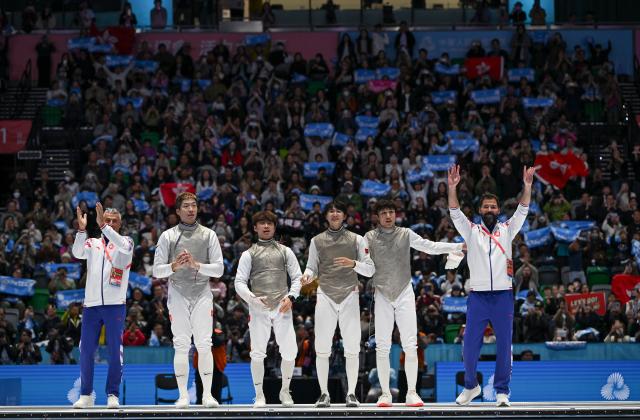 (251119) -- HONG KONG, Nov. 19, 2025 (Xinhua) -- Team Hong Kong and their coaches react after winning the men's team foil final of fencing at China's 15th National Games in Hong Kong, south China, Nov. 19, 2025. (Xinhua/Hu Huhu)