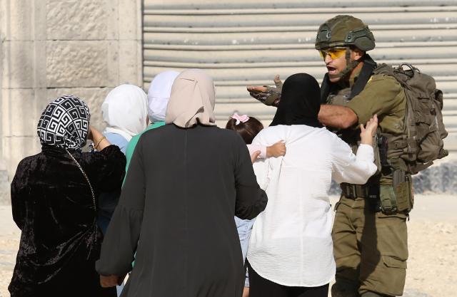 (251119) -- TULKARM, Nov. 19, 2025 (Xinhua) -- An Israeli soldier tries to prevent Palestinians from reaching their houses in Nur Shams refugee camp in the West Bank city of Tulkarm, Nov. 18, 2025. Palestinians took part in a demonstration demanding the right to return to their houses at the entrance of Nur Shams refugee camp, while Israeli soldiers assaulted the crowd and forced them to leave the area. (Photo by Nidal Eshtayeh/Xinhua)