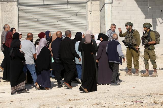 (251119) -- TULKARM, Nov. 19, 2025 (Xinhua) -- Israeli soldiers try to prevent Palestinians from reaching their houses in Nur Shams refugee camp in the West Bank city of Tulkarm, Nov. 18, 2025. Palestinians took part in a demonstration demanding the right to return to their houses at the entrance of Nur Shams refugee camp, while Israeli soldiers assaulted the crowd and forced them to leave the area. (Photo by Nidal Eshtayeh/Xinhua)