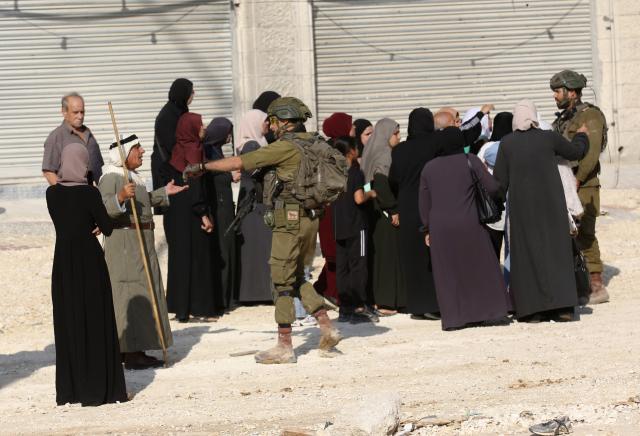(251119) -- TULKARM, Nov. 19, 2025 (Xinhua) -- Israeli soldiers try to prevent Palestinians from reaching their houses in Nur Shams refugee camp in the West Bank city of Tulkarm, Nov. 18, 2025. Palestinians took part in a demonstration demanding the right to return to their houses at the entrance of Nur Shams refugee camp, while Israeli soldiers assaulted the crowd and forced them to leave the area. (Photo by Nidal Eshtayeh/Xinhua)