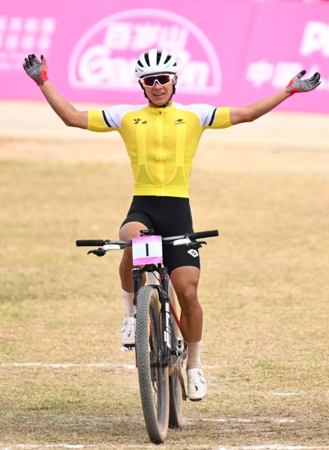 (251120) -- JIANGMEN, Nov. 20, 2025 (Xinhua) -- Lyu Xianjing of Yunnan crosses the finish line during the men's cross-country final of cycling mountain bike in Jiangmen, south China's Guangdong Province, Nov. 20, 2025. (Xinhua/Chen Zhonghao)