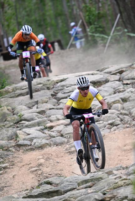 (251120) -- JIANGMEN, Nov. 20, 2025 (Xinhua) -- Yuan Jinwei (front) of Yunnan competes during the men's cross-country final of cycling mountain bike in Jiangmen, south China's Guangdong Province, Nov. 20, 2025. (Xinhua/Chen Zhonghao)