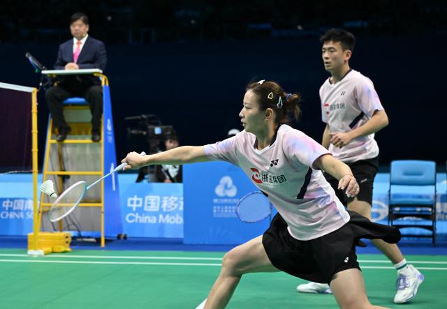 (251120) -- SHENZHEN, Nov. 20, 2025 (Xinhua) -- Zheng Siwei/Huang Yaqiong (L) of Zhejiang compete during the mixed doubles final of badminton against Zhou Zhihong/Wei Yaxin of Hunan at China's 15th National Games in Shenzhen, south China's Guangdong Province, Nov. 20, 2025. (Xinhua/Li Ziheng)