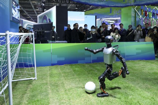 (251120) -- SHANGHAI, Nov. 20, 2025 (Xinhua) -- A robot playing football is pictured at an exhibition area of east China's Jiangsu Province during the 6th Yangtze River Delta International Cultural Industries Expo in east China's Shanghai, Nov. 20, 2025. Covering an area of 80,000 square meters, the expo kicked off in Shanghai on Thursday, with more than 1,500 exhibitors participating. (Xinhua/Wang Xiang)