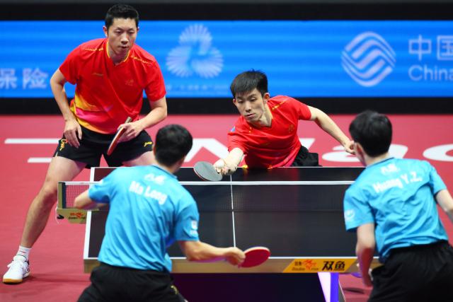 (251120) -- MACAO, Nov. 20, 2025 (Xinhua) -- Xu Xin (top L)/Zhou Kai (top R) of Shanghai compete in the match against Ma Long (bottom L)/Huang Youzheng of Beijing during the men's team final of table tennis between Beijing and Shanghai at China's 15th National Games in Macao, south China, Nov. 20, 2025. (Xinhua/Cheong Kam Ka)