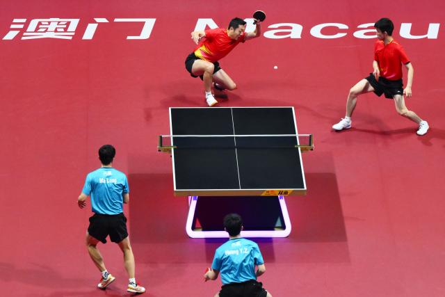 (251120) -- MACAO, Nov. 20, 2025 (Xinhua) -- Xu Xin (top L)/Zhou Kai (top R) of Shanghai compete in the match against Ma Long (bottom L)/Huang Youzheng of Beijing during the men's team final of table tennis between Beijing and Shanghai at China's 15th National Games in Macao, south China, Nov. 20, 2025. (Xinhua/Cheong Kam Ka)