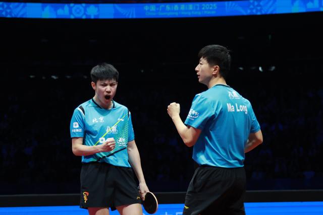 (251120) -- MACAO, Nov. 20, 2025 (Xinhua) -- Ma Long (R)/Huang Youzheng of Beijing celebrate scoring in the match against Xu Xin/Zhou Kai of Shanghai during the men's team final of table tennis between Beijing and Shanghai at China's 15th National Games in Macao, south China, Nov. 20, 2025. (Xinhua/Liang Xu)