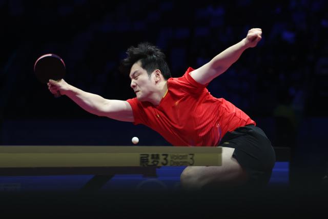 (251120) -- MACAO, Nov. 20, 2025 (Xinhua) -- Fan Zhendong of Shanghai hits a return in the match against Wang Chuqin of Beijing during the men's team final of table tennis between Beijing and Shanghai at China's 15th National Games in Macao, south China, Nov. 20, 2025. (Xinhua/Chen Bin)