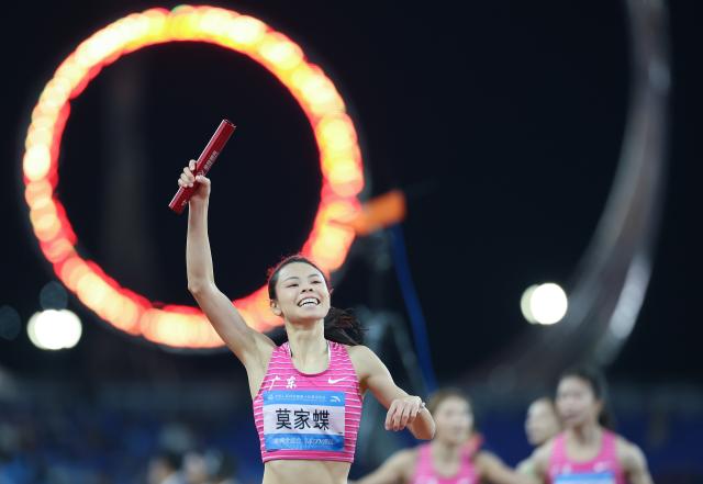 (251120) -- GUANGZHOU, Nov. 20, 2025 (Xinhua) -- Mo Jiadie of team Guangdong reacts after the women's 4x400m relay final of athletics at China's 15th National Games in Guangzhou, south China's Guangdong Province, Nov. 20, 2025. (Xinhua/Huang Wei)