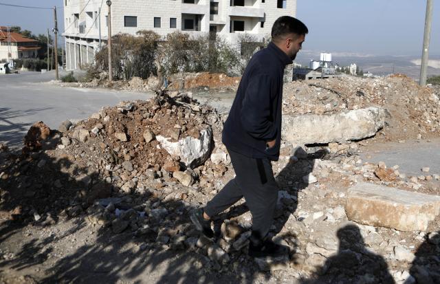 (251121) -- HEBRON, Nov. 21, 2025 (Xinhua) -- A Palestinian checks a blocked road following an Israeli military operation in the town of Beit Ummar, north of Hebron in the West Bank on Nov. 20, 2025. (Photo by Mamoun Wazwaz/Xinhua)