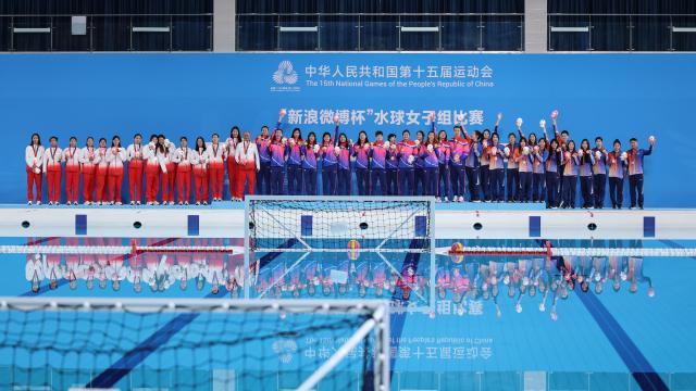 (251121) -- GUANGZHOU, Nov. 21, 2025 (Xinhua) -- Gold medalists team Shanghai (C), silver medalists team Tianjin (L), bronze medalists team Guangxi react during the awarding ceremony for the women's water polo at China's 15th National Games in Guangzhou, south China's Guangdong Province, Nov. 21, 2025. (Xinhua/Pan Yulong)