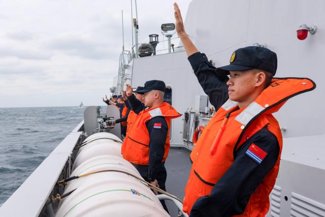 (251121) -- GUANGZHOU, Nov. 21, 2025 (Xinhua) -- Chinese sailors wave good-bye to their Vietnamese counterparts after the 39th joint patrol of Chinese and Vietnamese navies in the Beibu Gulf, on Nov. 20, 2025. Two fleets from the Chinese and Vietnamese navies conducted their 39th joint patrol in the waters of the Beibu Gulf from Nov. 19 to 20, in accordance with a relevant agreement and annual plans between the two sides. (Photo by Liu Pilu/Xinhua)