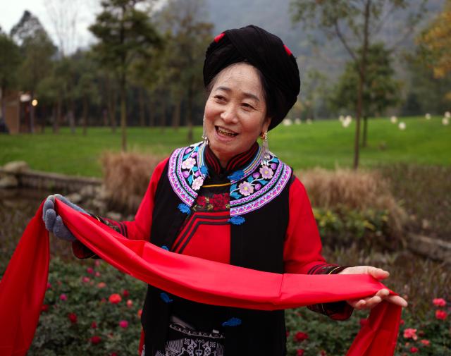 (251121) -- WENCHUAN, Nov. 21, 2025 (Xinhua) -- A woman in festive attire attends an event celebrating the Qiang New Year in Wenchuan County, Aba Tibetan and Qiang Autonomous Prefecture, southwest China's Sichuan Province, Nov. 20, 2025. An event celebrating the Qiang New Year was held here from Wednesday to Thursday, featuring a series of activities. (Photo by Lan Hongguang/Xinhua)