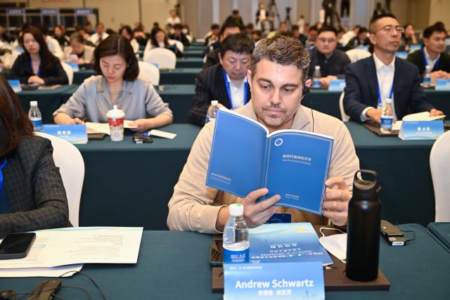 (251121) -- BEIJING, Nov. 21, 2025 (Xinhua) -- A guest reads the think tank report "New Era County Economics" during the Belt and Road Forum for International Think Tank Cooperation in Nanjing, east China's Jiangsu Province, Nov, 21, 2025. The report was released on Friday by Xinhua Institute, a national-level think tank affiliated with Xinhua News Agency, at the Belt and Road Forum for International Think Tank Cooperation held in Nanjing, capital of east China's Jiangsu Province. (Xinhua/Ji Chunpeng)