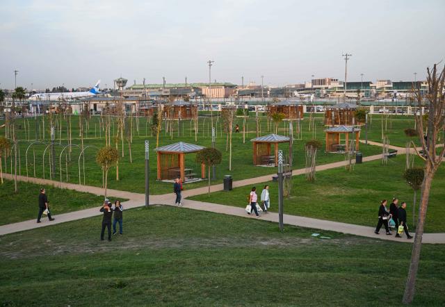 (251122) -- ISTANBUL, Nov. 22, 2025 (Xinhua) -- People stroll at the Ataturk Airport National Garden in Istanbul, Türkiye, Nov. 21, 2025. The former site of Istanbul's Ataturk Airport has recently been transformed into Türkiye's largest urban park, the Ataturk Airport National Garden, which has now opened to the public. (Xinhua/Liu Lei)