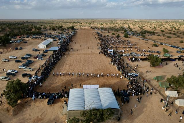 (251122) -- TRIPOLI, Nov. 22, 2025 (Xinhua) -- An aerial drone photo shows riders racing their horses at the Zelten traditional equestrian festival in Zelten, Libya, on Nov. 21, 2025. The festival, held from Nov. 21 to 22, aimed to promote the local traditional equestrian culture. (Photo by Hazem Turkia/Xinhua)