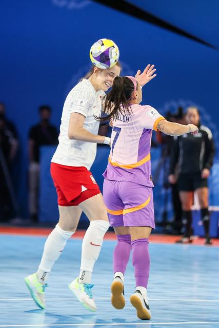 (251122) -- PASIG CITY, Nov. 22, 2025 (Xinhua) -- Izabela Tracz (L) of Poland vies against Katrina Guillou of the Philippines during the match between Poland and the Philippines at the FIFA Futsal Women's World Cup 2025 in Pasig City, the Philippines, Nov. 21, 2025. (Xinhua/Rouelle Umali)