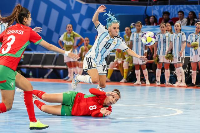 (251122) -- PASIG CITY, Nov. 22, 2025 (Xinhua) -- Silvina Nava (Top) of Argentina vies against Meryem Hajri (Bottom) of Morocco during the match between Argentina and Morocco at the FIFA Futsal Women's World Cup 2025 in Pasig City, the Philippines, Nov. 21, 2025. (Xinhua/Rouelle Umali)