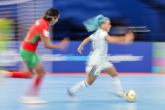 (251122) -- PASIG CITY, Nov. 22, 2025 (Xinhua) -- Silvina Nava (R) of Argentina vies against Soumia Hady of Morocco during the match between Argentina and Morocco at the FIFA Futsal Women's World Cup 2025 in Pasig City, the Philippines, Nov. 21, 2025. (Xinhua/Rouelle Umali)