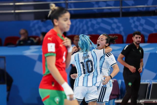 (251122) -- PASIG CITY, Nov. 22, 2025 (Xinhua) -- Silvina Nava (Back L) and Luciana Natta (Back R) of Argentina celebrate after scoring a goal during the match between Argentina and Morocco at the FIFA Futsal Women's World Cup 2025 in Pasig City, the Philippines, Nov. 21, 2025. (Xinhua/Rouelle Umali)
