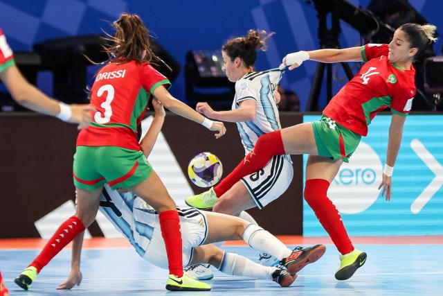 (251122) -- PASIG CITY, Nov. 22, 2025 (Xinhua) -- Ana Ontiveros (bottom C) of Argentina competes against players of Morocco during the match between Argentina and Morocco at the FIFA Futsal Women's World Cup 2025 in Pasig City, the Philippines, Nov. 21, 2025. (Xinhua/Rouelle Umali)