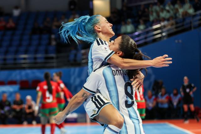 (251122) -- PASIG CITY, Nov. 22, 2025 (Xinhua) -- Silvina Nava (L) and Ana Ontiveros of Argentina celebrate after scoring a goal during the match between Argentina and Morocco at the FIFA Futsal Women's World Cup 2025 in Pasig City, the Philippines, Nov. 21, 2025. (Xinhua/Rouelle Umali)