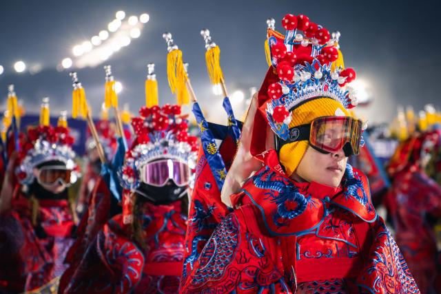 (251122) -- JILIN, Nov. 22, 2025 (Xinhua) -- Skiers dressed up in Peking Opera costumes prepare for a themed skiing show at the Lake Songhua Resort of Jilin City, northeast China's Jilin Province on Nov. 21, 2025. More than 260 skiers dressed up in Peking Opera costumes ski 1000m together to celebrate the new ski season. (Xinhua/Xu Chang)