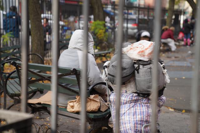 (251122) -- NEW YORK, Nov. 22, 2025 (Xinhua) -- A man with his luggage sits in a park bench near a shelter for the homeless in New York, the United States, on Nov. 21, 2025. It is estimated that more than 350,000 people were without home in New York City (NYC) by August this year, the highest level since the Great Depression of the 1930s, according to the Coalition for the Homeless. Most of them slept in NYC shelters or temporarily doubled-up in the homes of others, and thousands slept unsheltered on streets, parks and subways. (Xinhua/Zhang Fengguo)