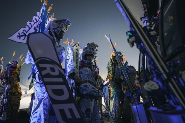 (251122) -- JILIN, Nov. 22, 2025 (Xinhua) -- Skiers dressed up in Peking Opera costumes gather together before a themed skiing show at the Lake Songhua Resort of Jilin City, northeast China's Jilin Province on Nov. 21, 2025. More than 260 skiers dressed up in Peking Opera costumes ski 1000m together to celebrate the new ski season. (Xinhua/Xu Chang)