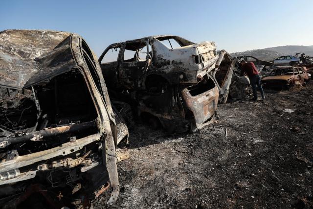 (251122) -- NABLUS, Nov. 22, 2025 (Xinhua) -- A Palestinian checks a vehicle scrapyard after Israeli settlers burned it in the town of Huwara, south of the West Bank city of Nablus, on Nov. 21, 2025. According to the official WAFA news agency, Israeli settlers set fire to a vehicle scrapyard here on Friday evening. (Photo by Ayman Nobani/Xinhua)
