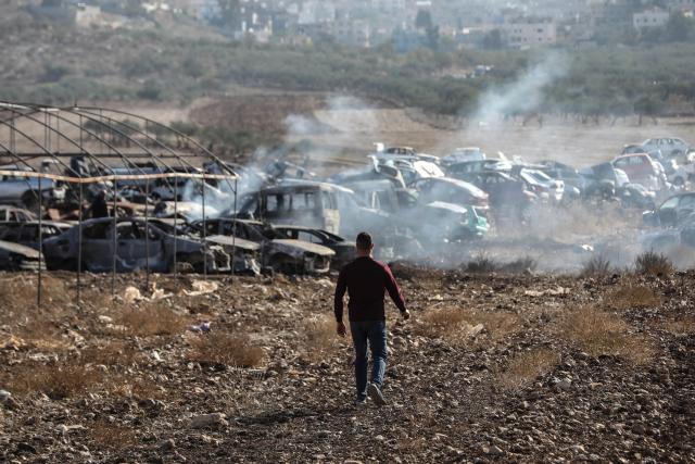 (251122) -- NABLUS, Nov. 22, 2025 (Xinhua) -- A Palestinian checks a vehicle scrapyard after Israeli settlers burned it in the town of Huwara, south of the West Bank city of Nablus, on Nov. 21, 2025. According to the official WAFA news agency, Israeli settlers set fire to a vehicle scrapyard here on Friday evening. (Photo by Ayman Nobani/Xinhua)