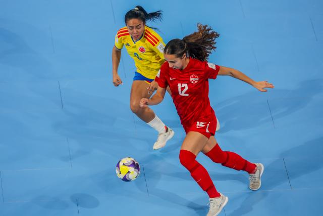 (251122) -- PASIG CITY, Nov. 22, 2025 (Xinhua) -- Magali Gagne (R) of Canada vies against Alejandra Apraez of Colombia during the match between Colombia and Canada at the FIFA Futsal Women's World Cup 2025 in Pasig City, the Philippines, Nov. 22, 2025. (Xinhua/Rouelle Umali)