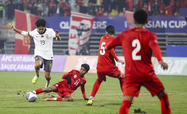 (251122) -- CHONGQING, Nov. 22, 2025 (Xinhua) -- Wan Xiang (1st L) of China vies with Ahmed Hani Ali Radhi of Bahrain during a Group A match of the AFC U17 Asian Cup 2026 qualifiers in Chongqing, China, Nov. 22, 2025. (Xinhua/Huang Wei)