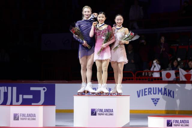 (251123) -- HELSINKI, Nov. 23, 2025 (Xinhua) -- Gold medalist Chiba Mone (C) of Japan, silver medalist Amber Glenn of the United States and bronze medalist Matsuike Rino (R) of Japan pose during the awarding ceremony for the women's skating event at the ISU Grand Prix of Figure Skating event Finlandia Trophy 2025 in Helsinki, Finland, Nov. 22, 2025. (Photo by Matti Matikainen/Xinhua)