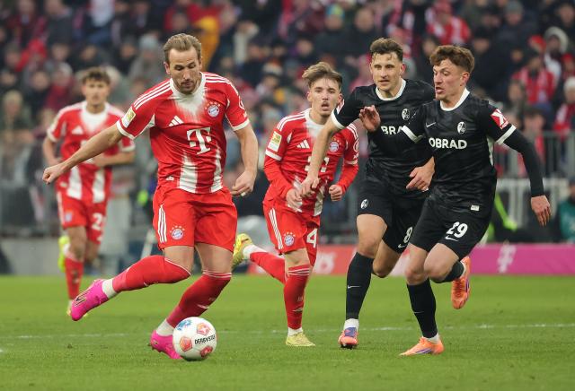 (251123) -- MUNICH, Nov. 23, 2025 (Xinhua) -- Harry Kane (2nd L) of Bayern Munich vies with Maximilian Eggestein (2nd R) and Philipp Treu (1st R) of SC Freiburg during the German first division Bundesliga football match between Bayern Munich and SC Freiburg in Munich, Germany, Nov. 22, 2025. (Photo by Philippe Ruiz/Xinhua)