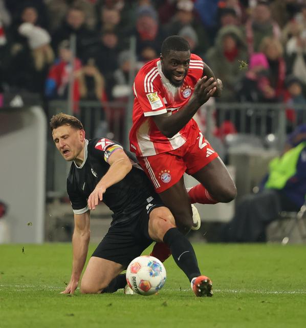 (251123) -- MUNICH, Nov. 23, 2025 (Xinhua) -- Dayot Upamecano (R) of Bayern Munich vies with Maximilian Eggestein of SC Freiburg during the German first division Bundesliga football match between Bayern Munich and SC Freiburg in Munich, Germany, Nov. 22, 2025. (Photo by Philippe Ruiz/Xinhua)