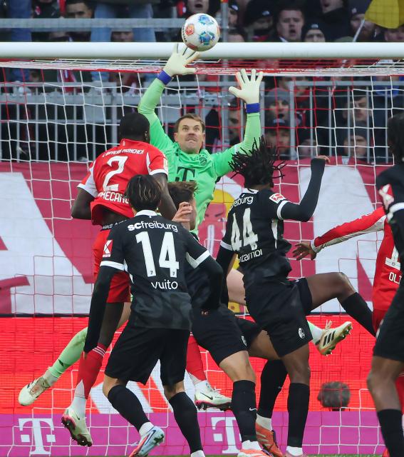 (251123) -- MUNICH, Nov. 23, 2025 (Xinhua) -- Bayern Munich's goalkeeper Manuel Neuer (rear) makes a save during the German first division Bundesliga football match between Bayern Munich and SC Freiburg in Munich, Germany, Nov. 22, 2025. (Photo by Philippe Ruiz/Xinhua)