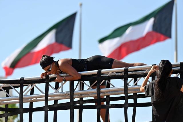 (251123) -- CAPITAL GOVERNORATE, Nov. 23, 2025 (Xinhua) -- A woman participates in a hindrance race in Capital Governorate, Kuwait, Nov. 22, 2025. The Hindrance Race - Flare Fitness Festival 2025 was held in Capital Governorate, Kuwait, with more than 1000 people participating. The race is a fun and challenging obstacle race with 21 obstacles in a distance of 4 kilometers for all fitness levels. (Photo by Asad/Xinhua)