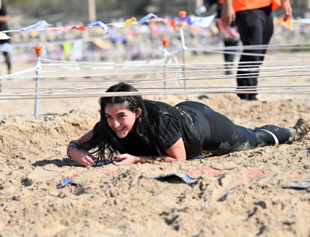 (251123) -- CAPITAL GOVERNORATE, Nov. 23, 2025 (Xinhua) -- A woman participates in a hindrance race in Capital Governorate, Kuwait, Nov. 22, 2025. The Hindrance Race - Flare Fitness Festival 2025 was held in Capital Governorate, Kuwait, with more than 1000 people participating. The race is a fun and challenging obstacle race with 21 obstacles in a distance of 4 kilometers for all fitness levels. (Photo by Asad/Xinhua)