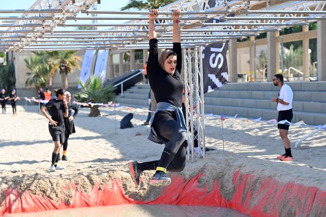 (251123) -- CAPITAL GOVERNORATE, Nov. 23, 2025 (Xinhua) -- Contestants participate in a hindrance race in Capital Governorate, Kuwait, Nov. 22, 2025. The Hindrance Race - Flare Fitness Festival 2025 was held in Capital Governorate, Kuwait, with more than 1000 people participating. The race is a fun and challenging obstacle race with 21 obstacles in a distance of 4 kilometers for all fitness levels. (Photo by Asad/Xinhua)