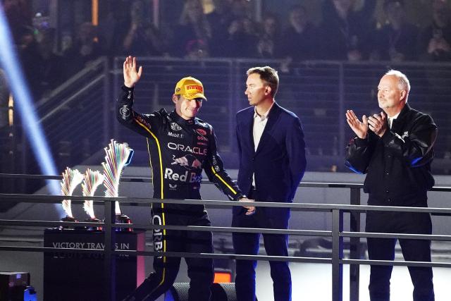 (251123) -- LAS VEGAS, Nov. 23, 2025 (Xinhua) -- Red Bull's Dutch driver Max Verstappenn (L) greets the spectators during the awarding ceremony for the 2025 Formula One U.S. Grand Prix at Las Vegas Circuit, in Las Vegas, the United States, Nov. 22, 2025. (Xinhua/Wu Xiaoling)