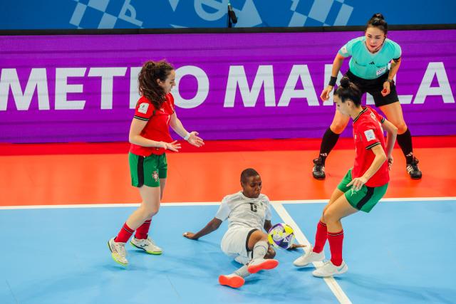 (251123) -- PASIG CITY, Nov. 23, 2025 (Xinhua) -- Sabina Mbuga (C) of Tanzania competes during the Group C match between Portugal and Tanzania at the FIFA Futsal Women's World Cup 2025 in Pasig City, the Philippines, Nov. 23, 2025. (Xinhua/Rouelle Umali)